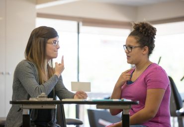 speech-therapist-speaking-with-patient-to-help-her-stop-stuttering speech-therapist-speaking-with-patient-to-help-her-stop-stuttering